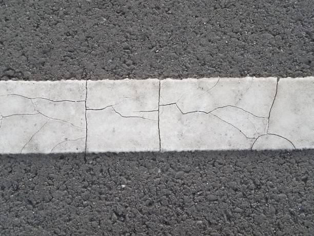 istock black asphalt with broken white paint line 1207074022