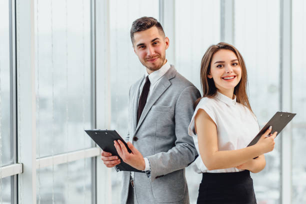 istock Excited business partners standing side by side, motivated for better teamwork result. 1207074226