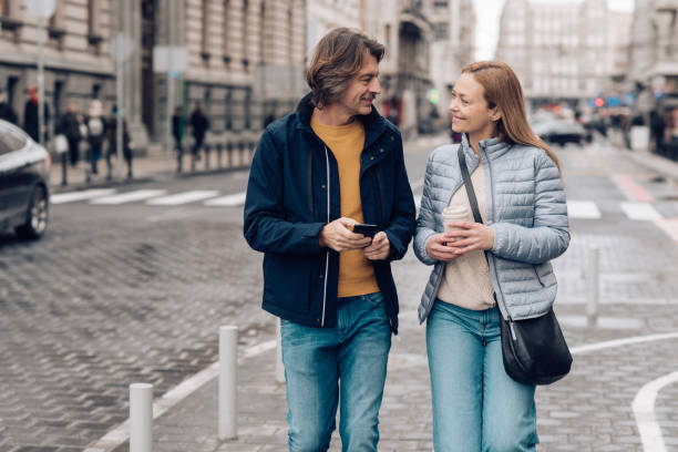 istock Two adults walking down the street and enjoying 1207074278