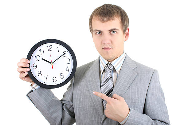 istock young businessman holding a clock 120707468