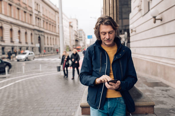 istock Mature man surfing the net while waiting for someone 1207075519