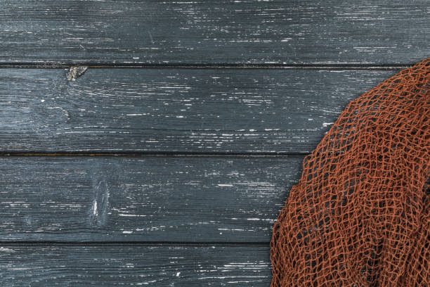 istock Wooden background with old fishing net. 1207075905