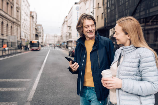 istock Mature man walking through the city with his partner 1207075920