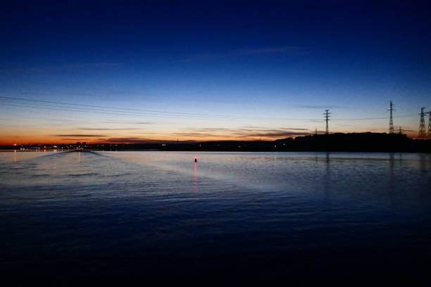 istock Find & Replace Sunset and blue skies over the forest which is in silhouette on the water's edge on Lake Ladoga. Water reflecting the light 1207076126