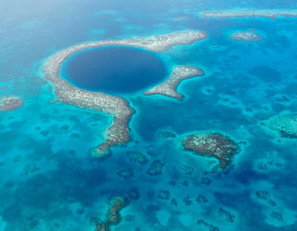 blick auf great blue hole und lighthouse reef in belize - lighthouse reef stock-fotos und bilder