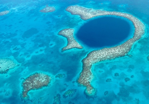 Aerial views of Great Blue Hole and Lighthouse Reef in Belize