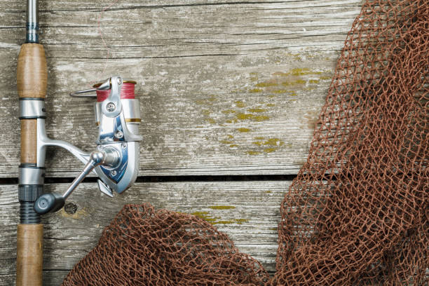 istock Fishing gear, hooks and baits on a wooden background 1207077197