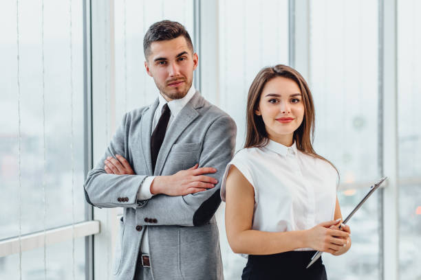 istock Excited business partners standing side by side, motivated for better teamwork result. 1207077307