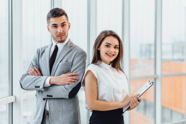 istock Excited business partners standing side by side, motivated for better teamwork result. 1207077388