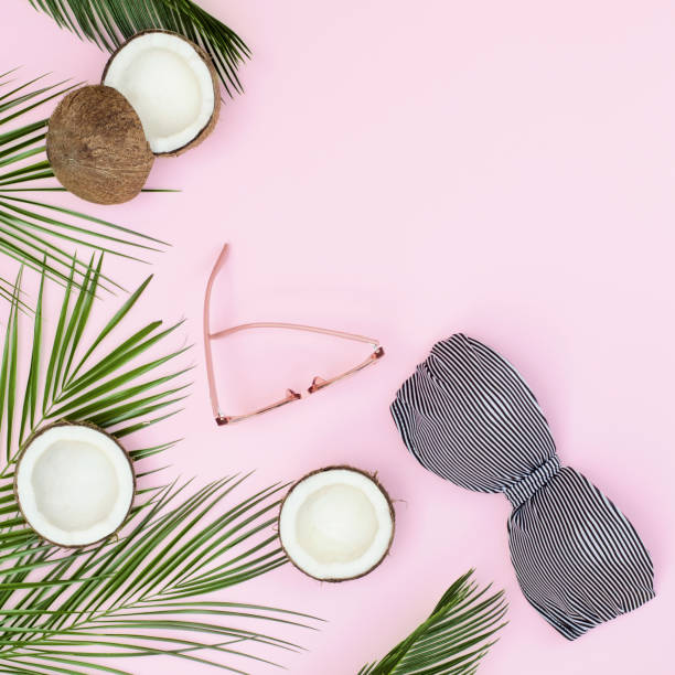 istock Bright composition with a swimsuit, glasses and a palm tree on a pink background. 1207078276