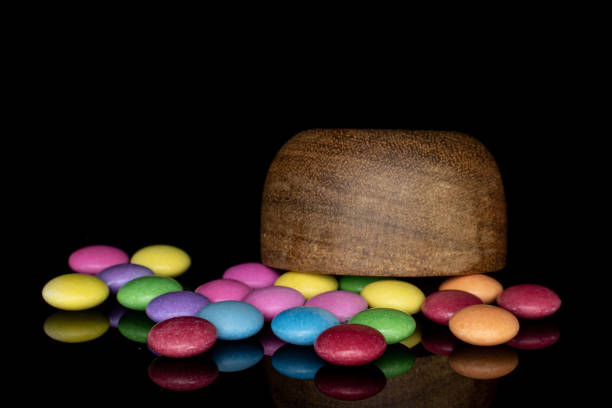 istock Sweet colourful candy isolated on black glass 1207079470