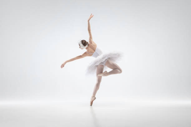 istock Young graceful ballerina on white studio background 1207080129