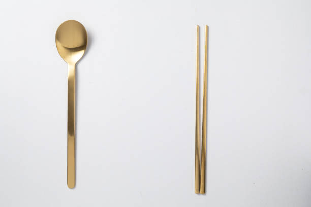 golden spoon chopstick korea style on white background - mannered imagens e fotografias de stock