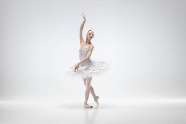 istock Young graceful ballerina on white studio background 1207080404