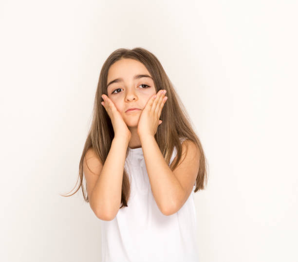 istock Bored, thoughtful little girl with both hands on her chin 1207081423