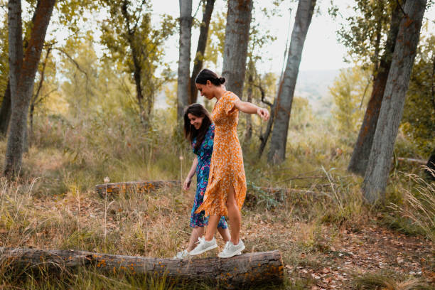 istock Two young women walking through the forest wearing dresses 1207081736