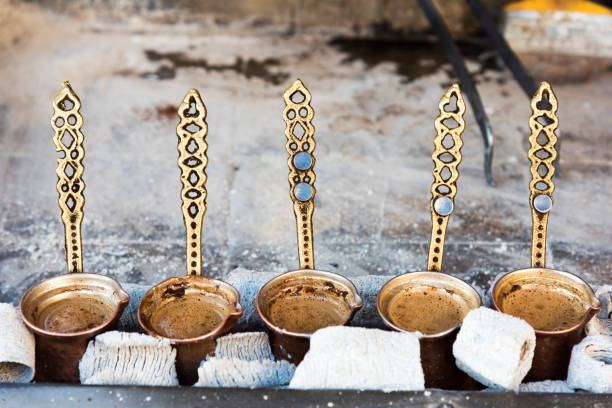 istock Traditional Turkish coffee cooked in hot sand and three copper cezve 1207083040