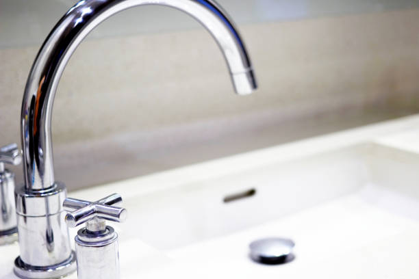 istock sink faucet closed up with blur sink background 1207083046