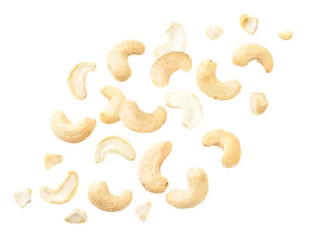 Close-up of cashew nuts flying on a white background. Isolated