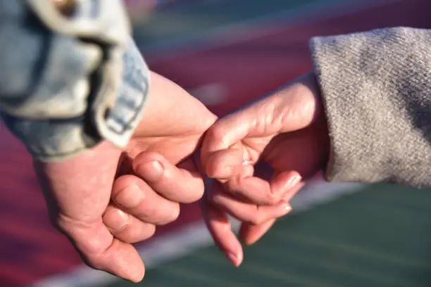 Photo of Close up photo of couple holding hands.