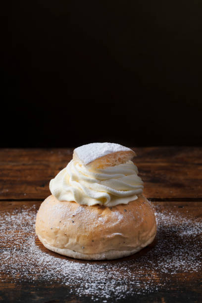 istock Semlor traditional scandinavian cream filled cardamom buns with almond paste. Close up. 1207087708