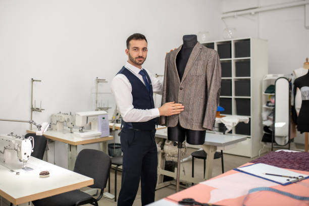 istock Male fashion standing next to dummy with jacket 1207087874
