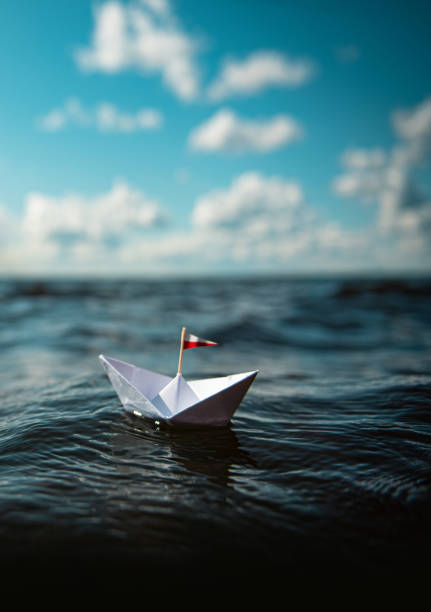 istock Paper ship iin big waves 1207087891