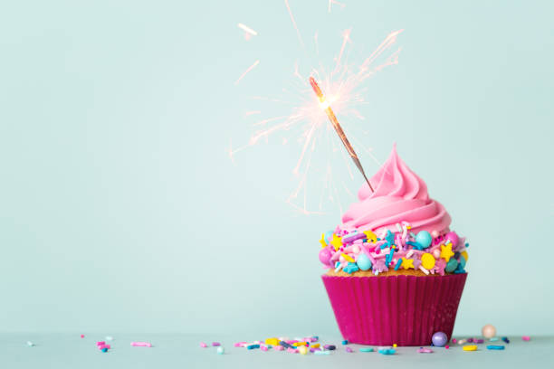 istock Birthday cupcake with sparkler and sprinkles 1207090355