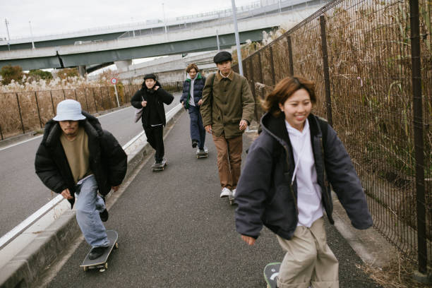 Young people skateboarding on city streets