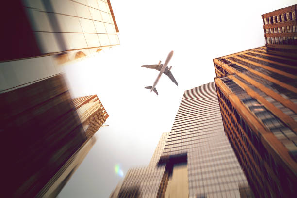istock Manhattan office building from below and a jet 1207090907