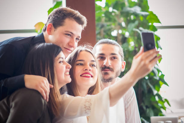 istock Group of friends looking at a mobile phone 1207091306