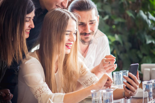 istock Group of friends looking at a mobile phone 1207091310