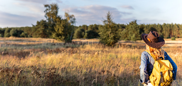 Female tourist standing in nature at summer