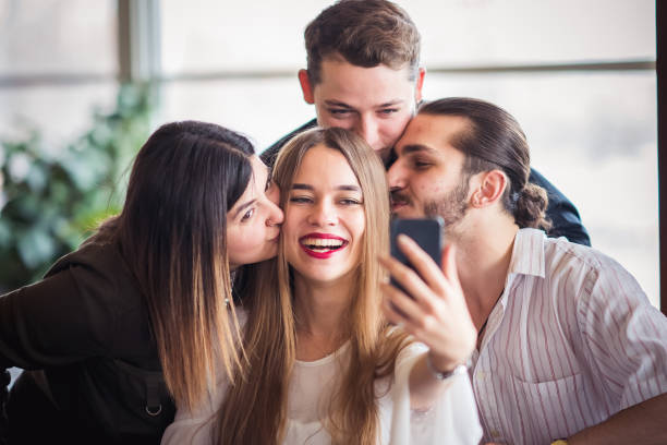 istock Group of friends looking at a mobile phone 1207092467