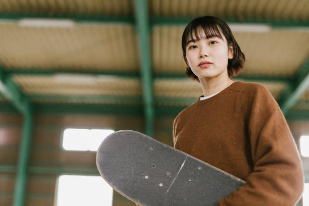 istock Portrait of young skateboarder looking at camera 1207092575