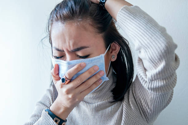 Asian woman with face mask protection of Coronavirus in human lungs stock photo