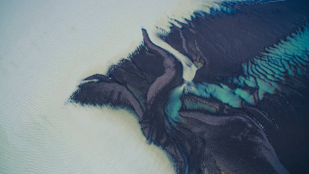 istock Blue river delta flowing into the pond. Top view. Aerial photography. Interesting textures. 1207093237