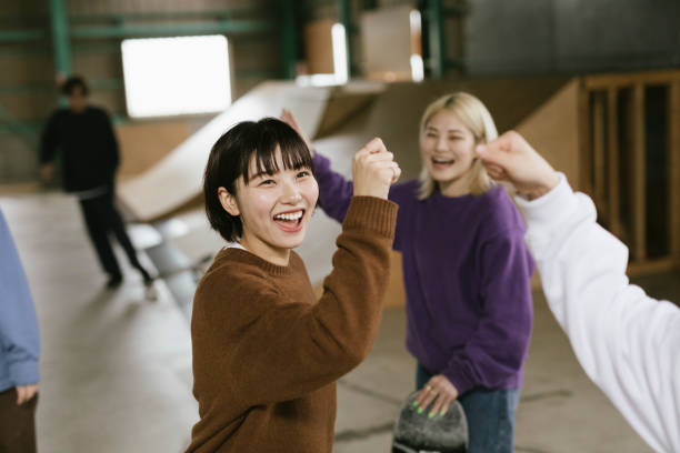 Female Skateboarders Greeting Each Other