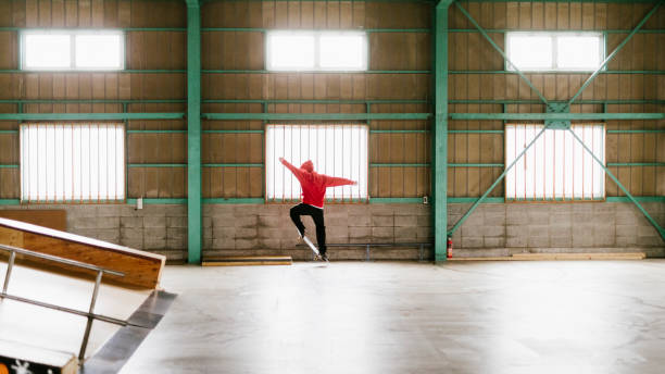 Young skateboarder practicing his skills in a indoor skatepark in Tokyo.