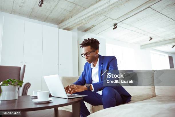 Serious Financial Expert Using Laptop In Office Stock Photo - Download Image Now - Financial Advisor, African-American Ethnicity, Men