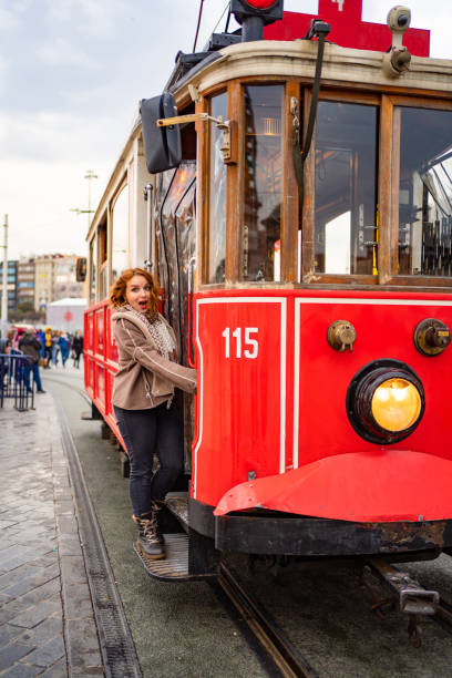 istock funny girl stand running Board red tram 1207095434