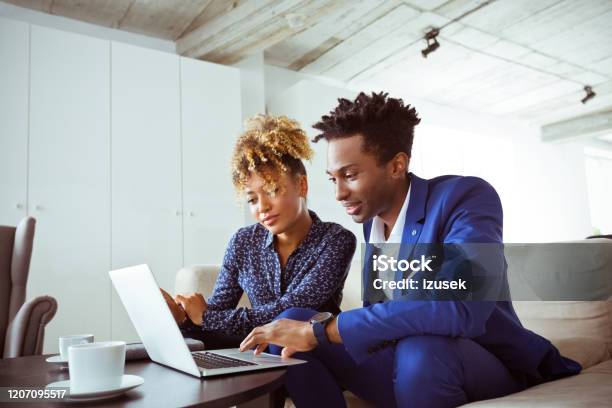 Skilled Corporate Workers Planning Finance On Sofa Stock Photo - Download Image Now - Business Meeting, Multiracial Group, UK