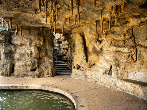 Cave Exterior of River Walk in downtown San Antonio. Project started in 1939 and was completed by the WPA in 1941. The goal was to transform the city area with way to battle floods. The canal water way provided San Antonio with green parks and two parallel sidewalks. The water depth of the Venice-like canal ranges from just two to four feet. Along the way, many tourist attractions: art work, museums, restaurants, hotels.