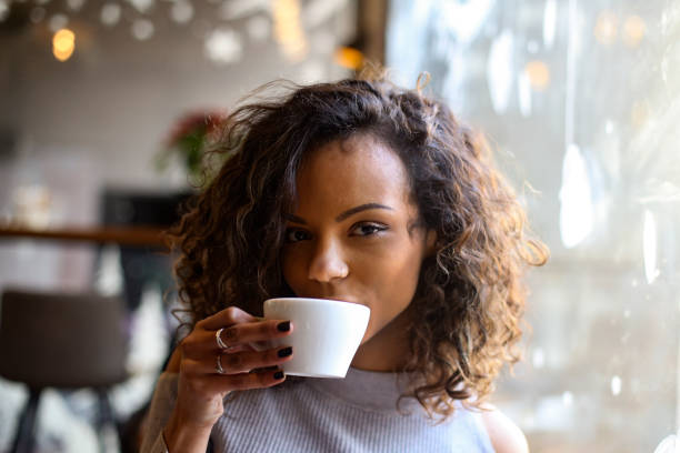 istock Young woman drinking coffee in a bar 1207097614