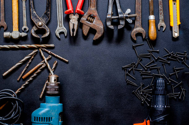 istock Tools for repair and reconstruction in home conditions lie on a black background 1207098687