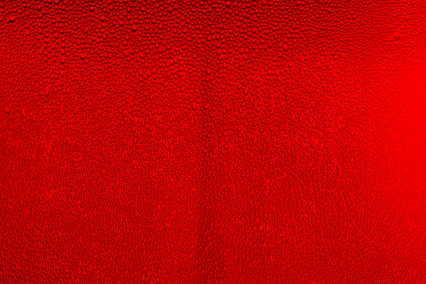 Water Drops background on the red glossy surface, Rain droplets on red texture. Natural fresh background.