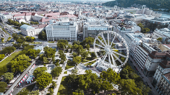 Drone panoramic skyline view of Deák Ferenc square with ferris wheel.
