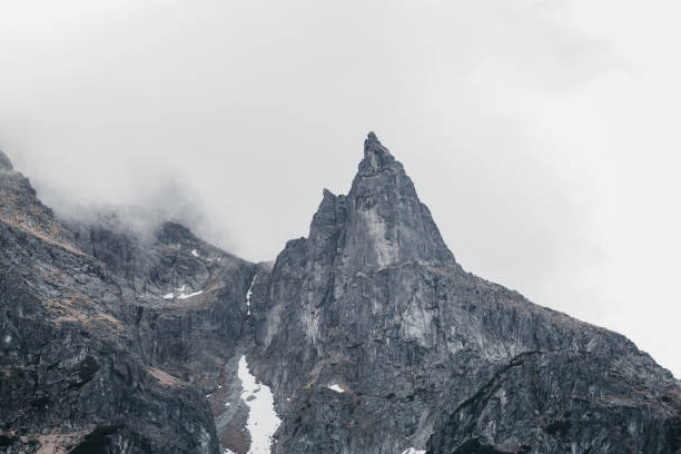 istock Epic aerial shot from mountain peak surrounded by mist 1207099106