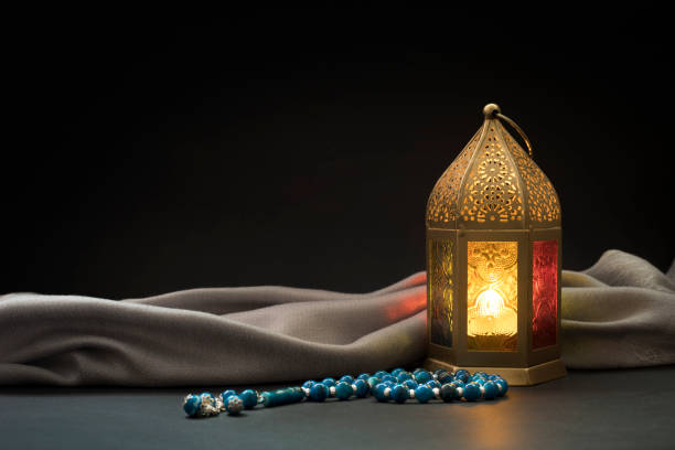 istock Ramadan Lantern and Blue rosary beads in front of dark background. 1207100023