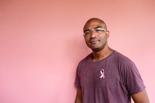Man with pink October ribbon on shirt
